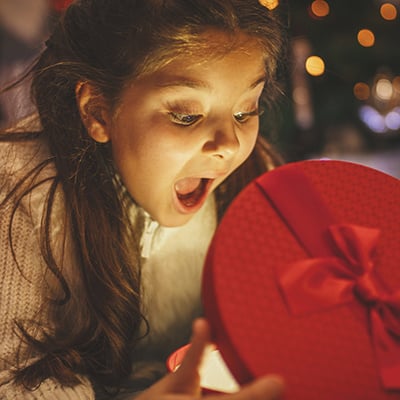 excited girl opening holiday gift box