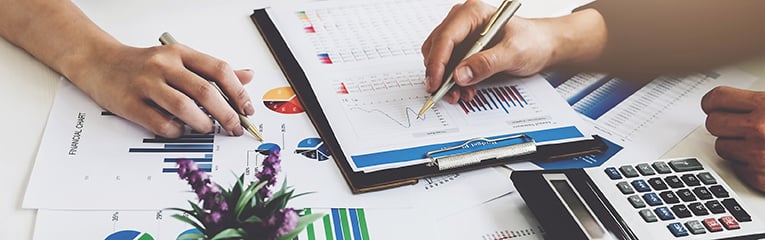 Business financial concept. busines sman and partner pointing graph paper are meeting to plan sales to meet targets set in next year