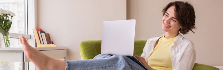 Woman-just-purchased-gap-insurance-on-her-laptop-and-is-smiling-knowing-her-car-loan-is-covered.