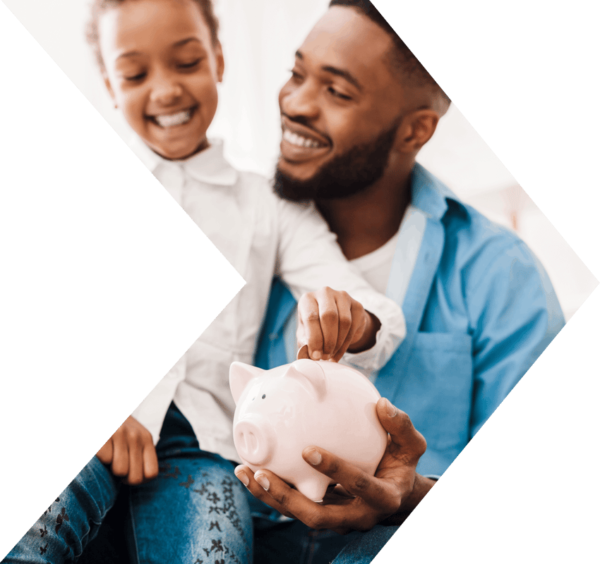 Dad teaching kid about savings accounts with a piggy bank