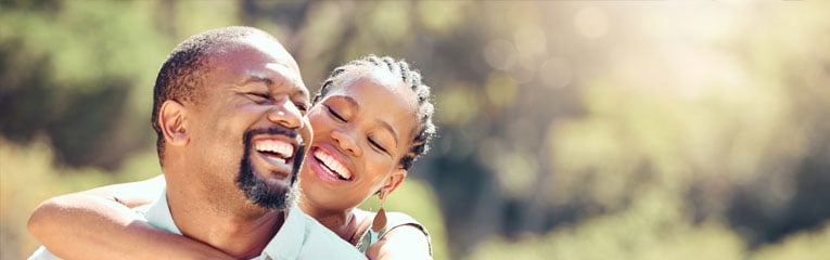 Couple-smiling-and-hugging-after-their-personal-loan-for-debt-consolidation-application-has-been-approved.