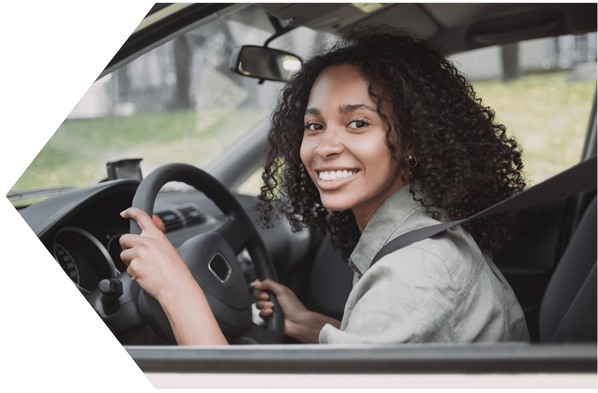 Young woman driving away with a Peach State Auto Loan