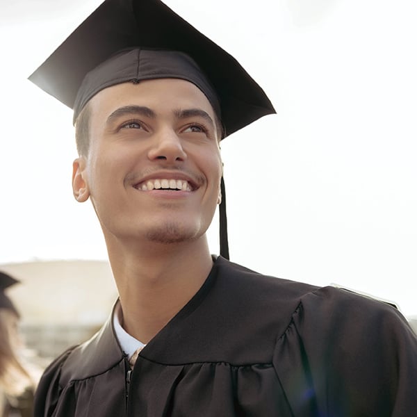 Excited graduate in cap and gown