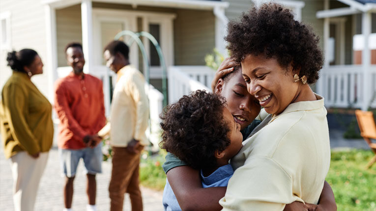 An ARM Mortgage gave this family hugging on their lawn a new home.